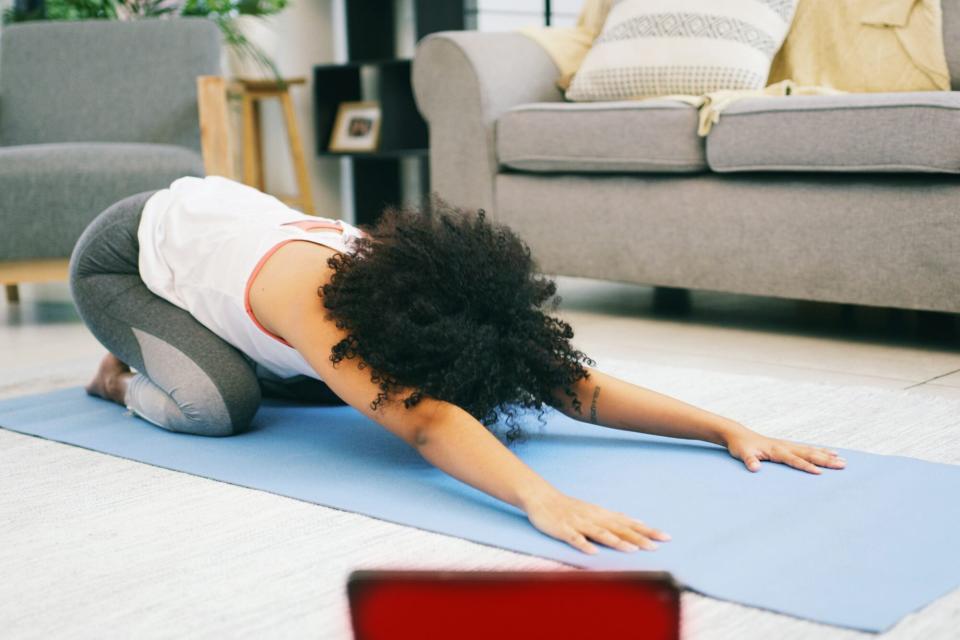 practicing yoga in living room