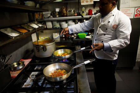 Abdul Ahad, owner of the City Spice curry house, cooks a vegan meal in the kitchen of his restaurant on Brick Lane in London, Britain January 7, 2019. Picture taken January 7, 2019. REUTERS/Simon Dawson