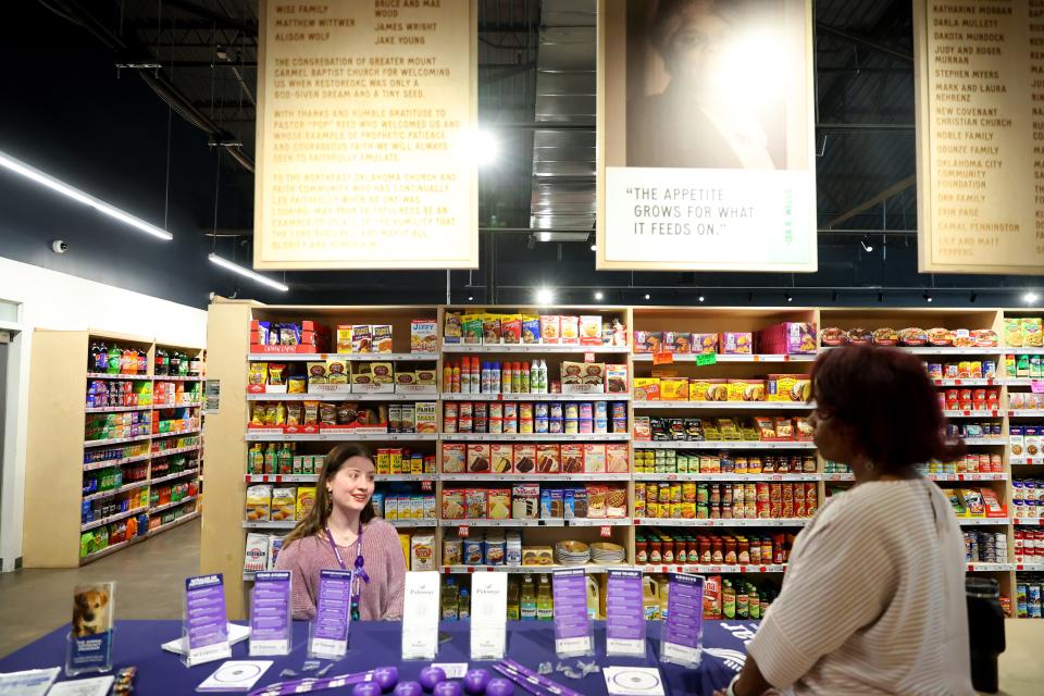 Maria Peguero, lead community health worker, talks with Madisen Richards, with Palomar, on March 13 at the Community Resource Room at Market at Eastpoint in Oklahoma City.