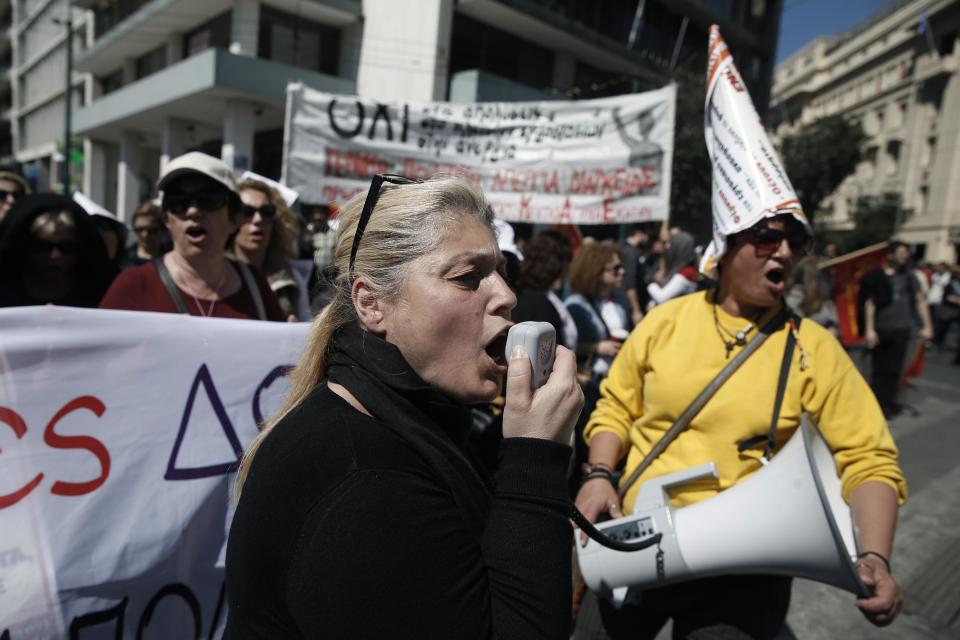 A protesting cleaning staff fired by the Finance Ministry chant slogans through a loudspeaker during a rally in Athens, on Wednesday, March 19, 2014. Greek civil servants, including hospital and teaching staff, have started a two-day strike against austerity measures imposed under the debt-mired country's international bailout commitment.(AP Photo/Petros Giannakouris)