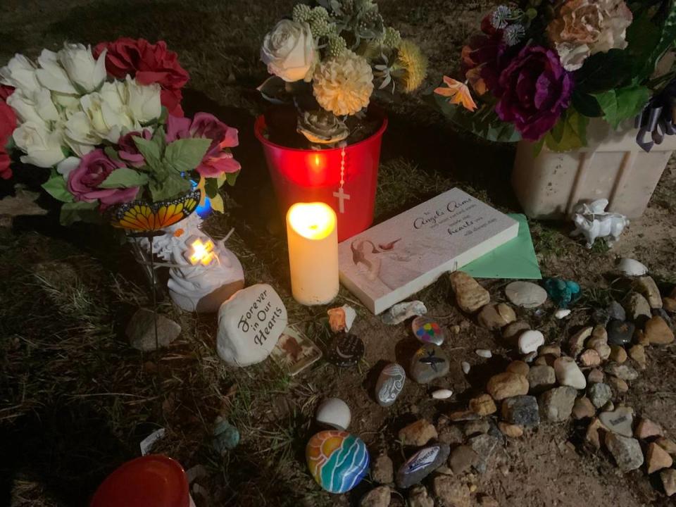 An electric candle is lit at a memorial for Gisele Lara who was killed in an apparent murder-suicide on Columbus State University’s main campus.