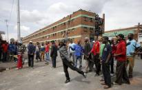 Locals gesture outside a hostel during anti-immigrant related violence in Johannesburg, April 17, 2015. REUTERS/Siphiwe Sibeko