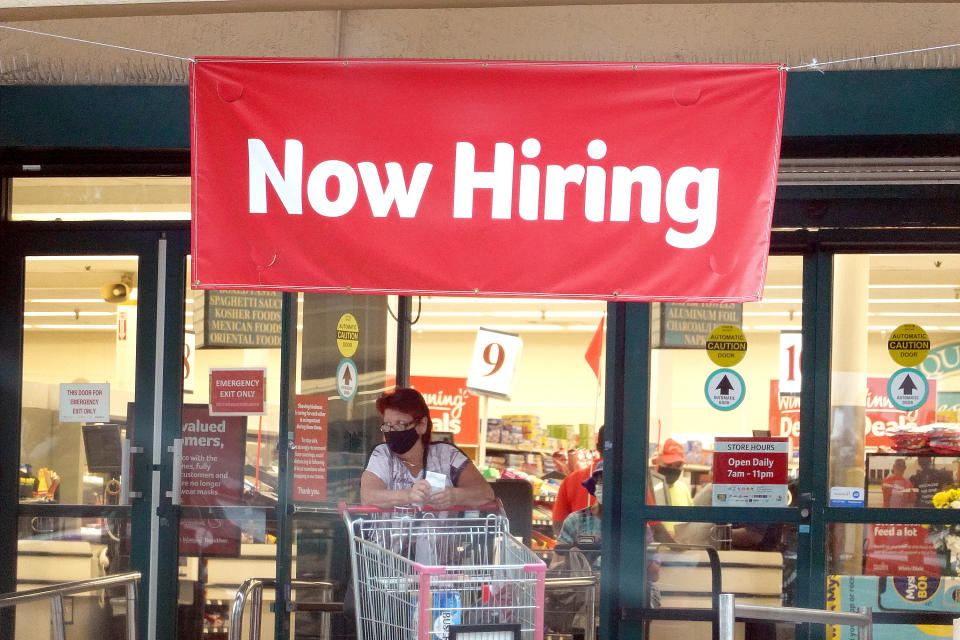 HALLANDALE, FLORIDA - SEPTEMBER 21: A Now Hiring sign hangs near the entrance to a Winn-Dixie Supermarket on September 21, 2021 in Hallandale, Florida. Government reports indicate that Initial jobless benefit claims rose 20,000 to 332,000 in the week ended Sept. 11. (Photo by Joe Raedle/Getty Images)