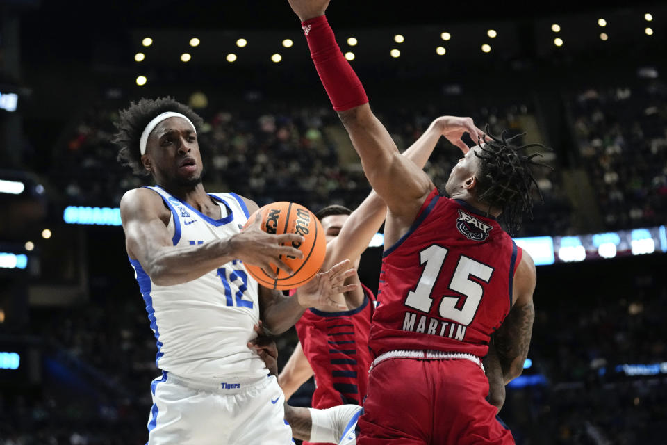 Memphis Tigers forward DeAndre Williams (12) pulls down a rebound from Florida Atlantic guard Alijah Martin (15) in the first half of a first-round college basketball game in the NCAA Tournament Friday, March 17, 2023, in Columbus, Ohio. (AP Photo/Paul Sancya)