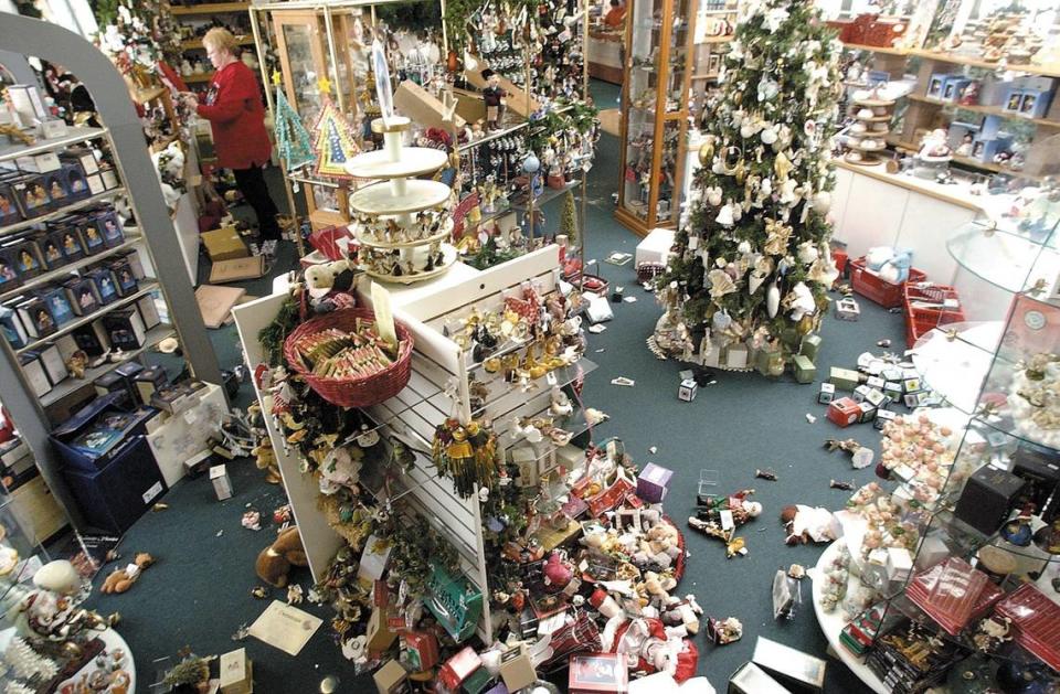 Jinny Cahill, owner of Forever Christmas in Morro Bay, cleans up after the San Simeon Earthquake on Dec. 23, 2003.