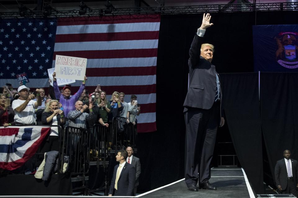 President-elect Donald Trump waves to the crowd as he arrives onstage at the DeltaPlex Arena, December 9, 2016, in Grand Rapids, Michigan. President-elect Donald Trump is continuing his victory tour across the country.