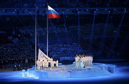 The Olympic flag is raised next to the flag of Russia during the opening ceremony of the 2014 Sochi Winter Olympics, February 7, 2014. REUTERS/Mark Blinch (
