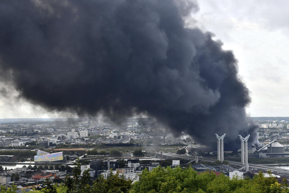 Black smoke is pictured after a fire broke at a chemical plant in Rouen, Normandy, Thursday, Sept.26, 2019. An immense mass of black smoke is rising over Normandy as firefighters battle a blaze at a chemical plant, and authorities closed schools in 11 surrounding towns and asked residents to stay indoors. (AP Photo/Stephanie Peron)