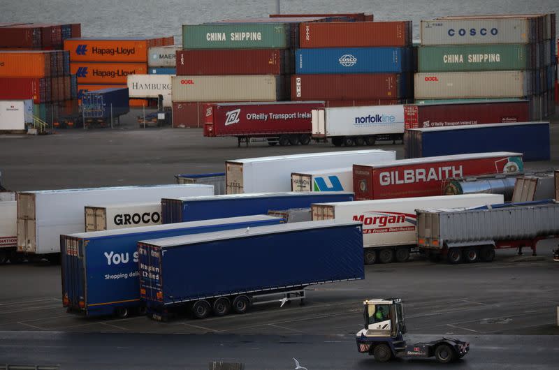 Port vehicle drives past trailers and shipping containers at the Port of Belfast