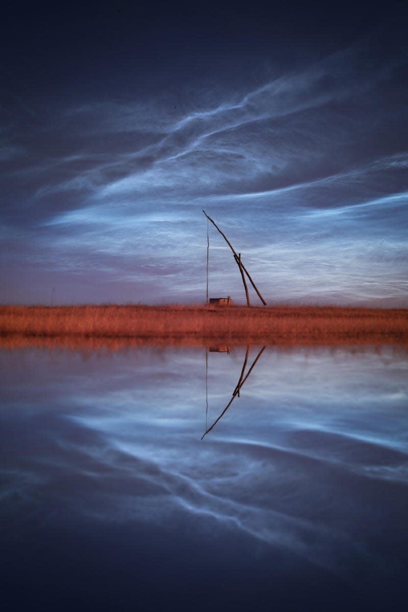 Clouds over Hungary, mirrored in the pond below.