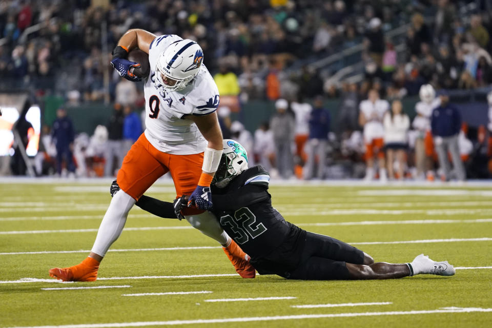UTSA tight end Oscar Cardenas (9) pulls in a pass reception against Tulane safety Bailey Despanie (32) in the second half of an NCAA college football game in New Orleans, Friday, Nov. 24, 2023. Tulane won 29-16. (AP Photo/Gerald Herbert)