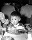 <p>When this 2-year-old Japanese youngster left his home in the Los Angeles Harbor area and was taken to the Japanese Assembly Center at Santa Anita Race Track April, 5, 1942 along with other evacuees he brought his appetite along. He was served this dinner in the mess hall formerly used by race track employees. (AP Photo) </p>