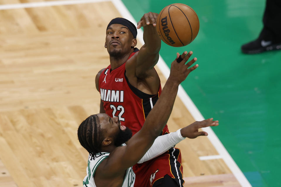 Miami Heat forward Jimmy Butler (22) blocks a shot by Boston Celtics guard Jaylen Brown during the second half of Game 2 of the NBA basketball playoffs Eastern Conference finals in Boston, Friday, May 19, 2023. (AP Photo/Michael Dwyer)