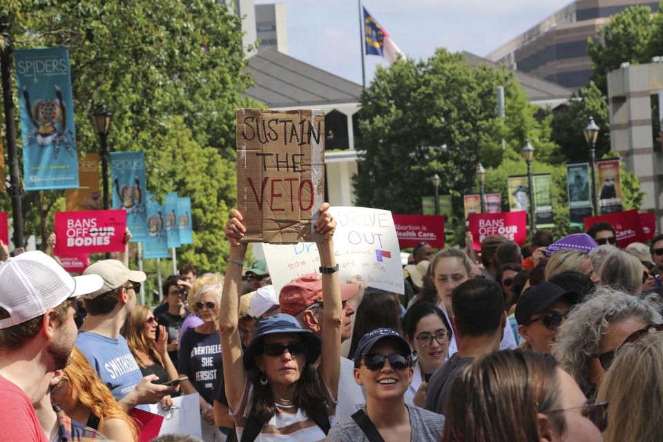 Hundreds of abortion-rights supporters rally outside the North Carolina Legislative Building in Raleigh, N.C, on Saturday, May 13, 2023, to urge Republican legislators to sustain Democratic Gov. Roy Cooper's veto of new abortion restrictions. (AP Photo/Hannah Schoenbaum)