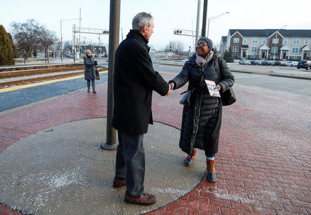 U.S. Congressman Daniel Lipinski (C) campaigns for re-election at the Chicago Ridge Metra commuter train station in Chicago Ridge, Illinois, U.S. January 25, 2018. Picture taken January 25, 2018. REUTERS/Kamil Krzacznski