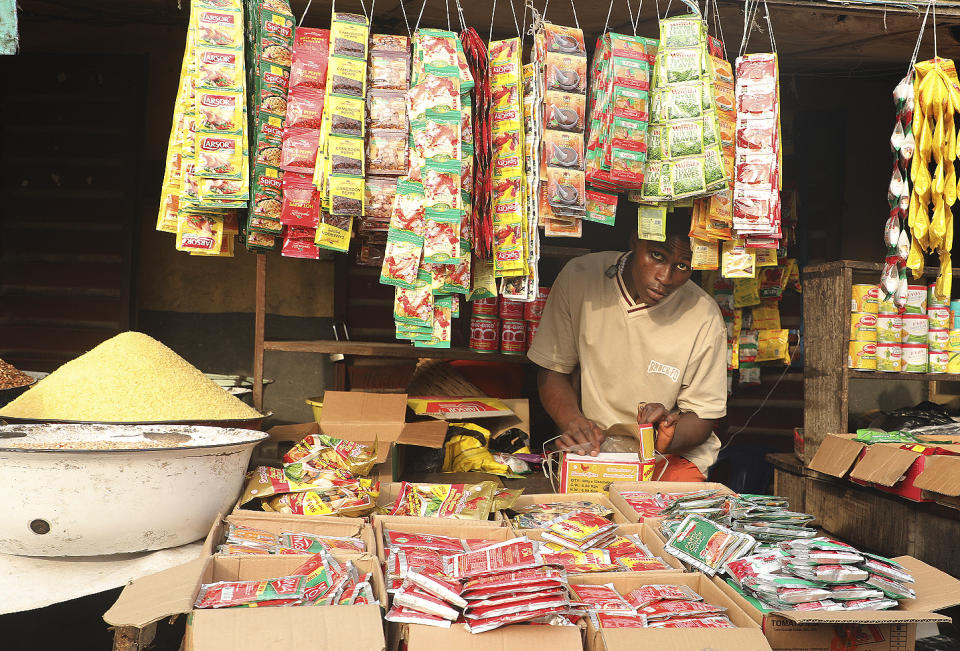 A women sells sachet soup items at the Mile 12 Market in Lagos, Nigeria, Friday, Feb. 16, 2024. Nigerians are facing one of the West African nation's worst economic crises in as many years triggered by a surging inflation rate which follows monetary policies that have dipped the local currency to an all-time low against the dollar, provoking anger and protests across the country. (AP Photo/Mansur Ibrahim)