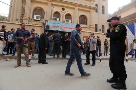 Security forces and people gather at the site of attack on a church in the Helwan district south of Cairo, Egypt December 29, 2017. REUTERS/Amr Abdallah Dalsh