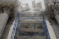 Scaffolding stands in front of a damaged painting and a section of the damaged vault, during the early stages of reconstruction work at Nuestra Senora de Los Angeles, or Our Lady of Angels church, three years after an earthquake collapsed nearly half of its 18th-century dome in Mexico City, Tuesday, Oct. 6, 2020. The chapel built in the late 1500s once stood here, of which only a portion of one wall remains, while the collapsed dome was built between 1740 and 1884. (AP Photo/Rebecca Blackwell)