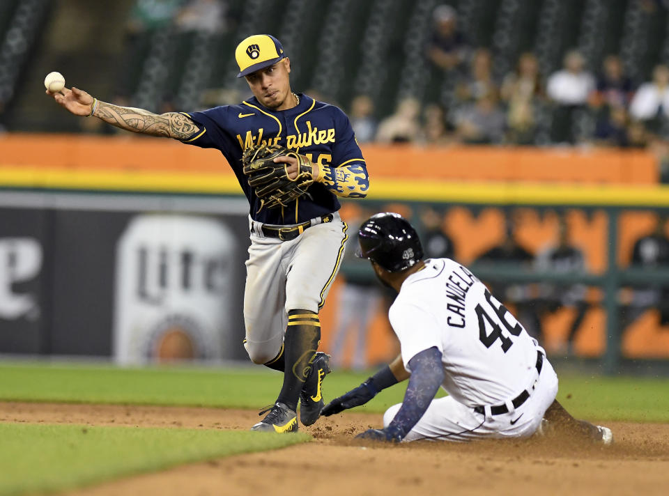 Milwaukee Brewers second baseman Kelton Wong throws to first after forcing out Detroit Tigers' Jeimer Candelario on a double play hit into by Eric Haase during the fifth inning of a baseball game in Detroit, Tuesday, Sept. 14, 2021. (AP Photo/Lon Horwedel)