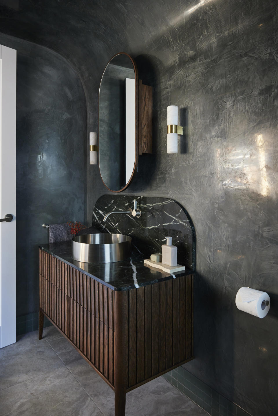 Textured black wall and vanity. 