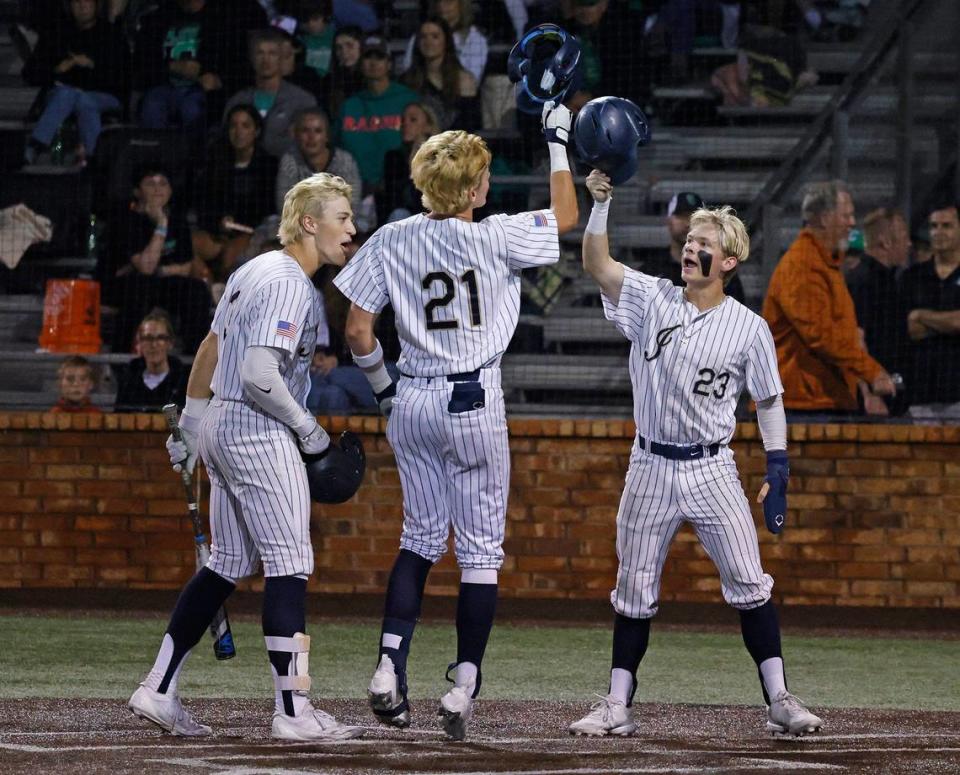 Keller first baseman Landry Stamps and right fielder Jackson Ridge meet third baseman Cole Koeninger at home after Koeninger;s home run ended a UIL District 6A Region 1 Quarterfinals baseball game at L.D. Bell in Hurst, Texas, Thursday, May 16, 2024.