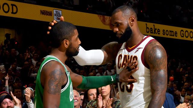 James and Irving embrace ahead during the season opener. Pic: Getty