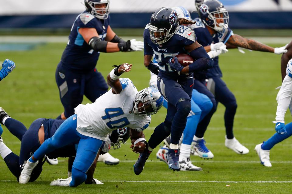 Titans running back Derrick Henry breaks away from Lions linebacker Jarrad Davis during the first half Sunday, Dec. 20, 2020, in Nashville, Tenn.