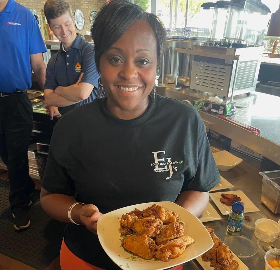 Dara J. Bess, owner of EJs Soul Food and Vegan, holding one of her specialties, fried chicken. Courtesy of Denise, CharlotteFive.