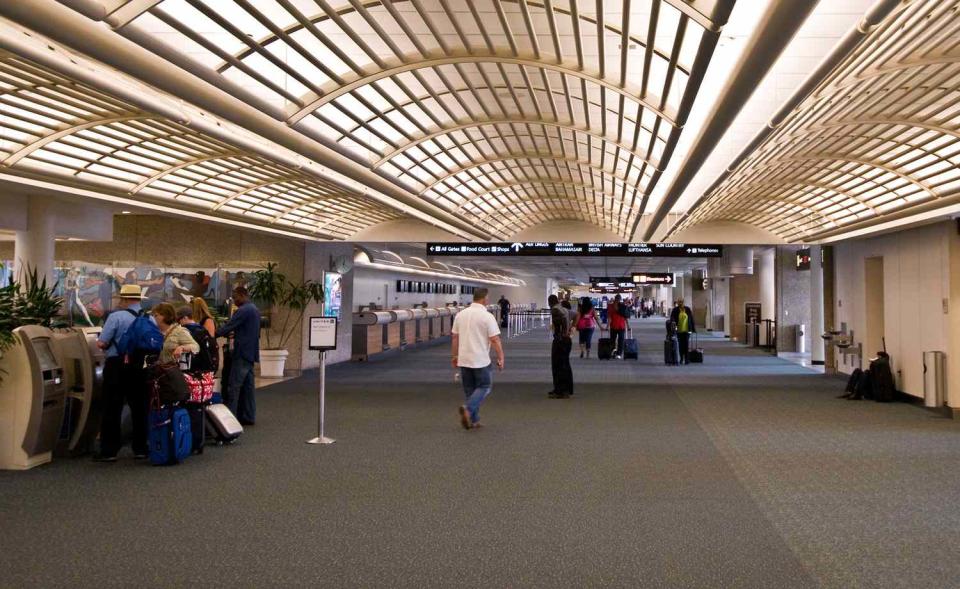 Modern architecture and travelers in the Orlando International Airport.