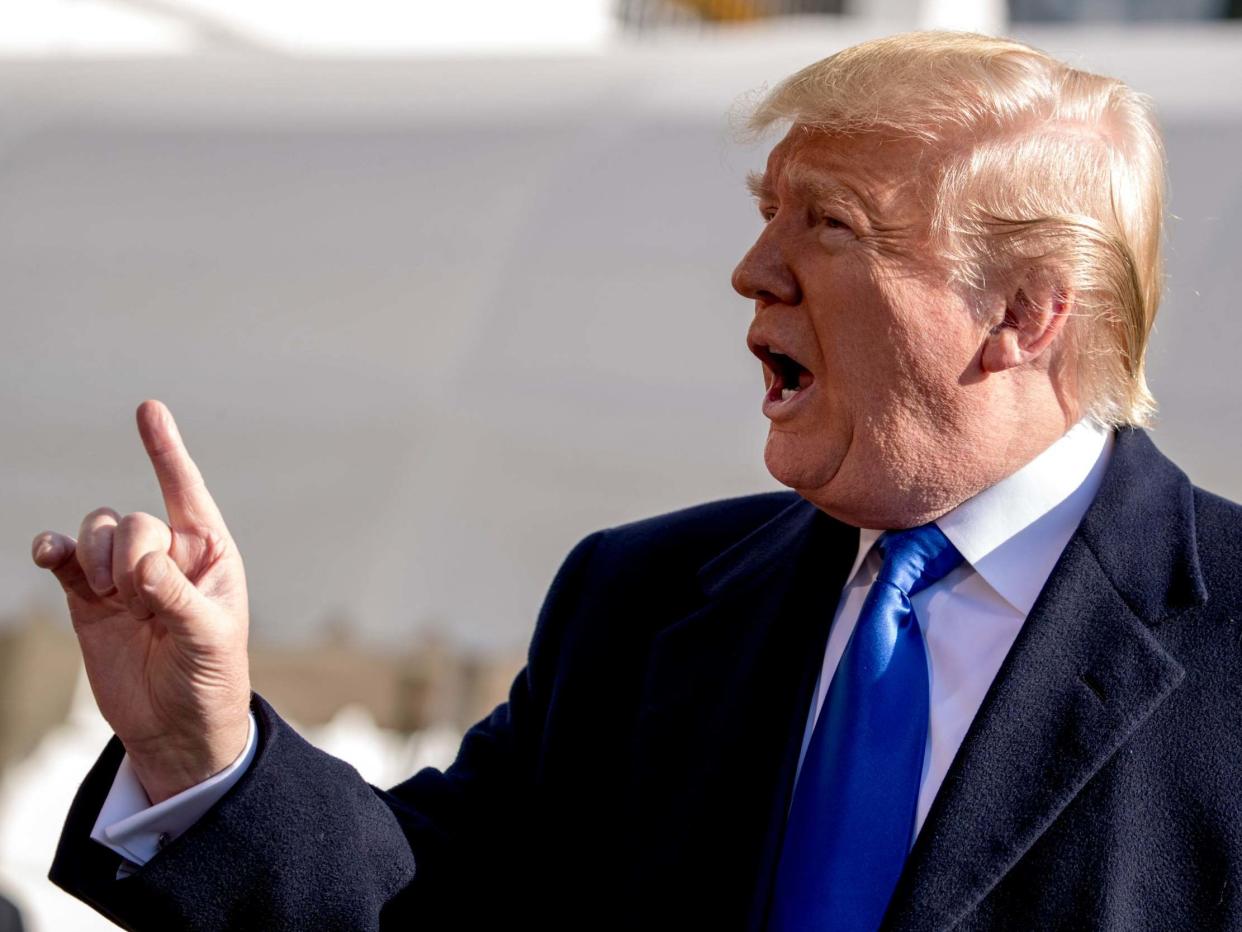 Donald Trump tells a reporter to be quiet as he speaks on the South Lawn of the White House in Washington on Friday 8 November 2019, before boarding Marine One for a short trip to Andrews Air Force Base, Maryland and then on to Georgia to meet with supporters: Andrew Harnik/AP