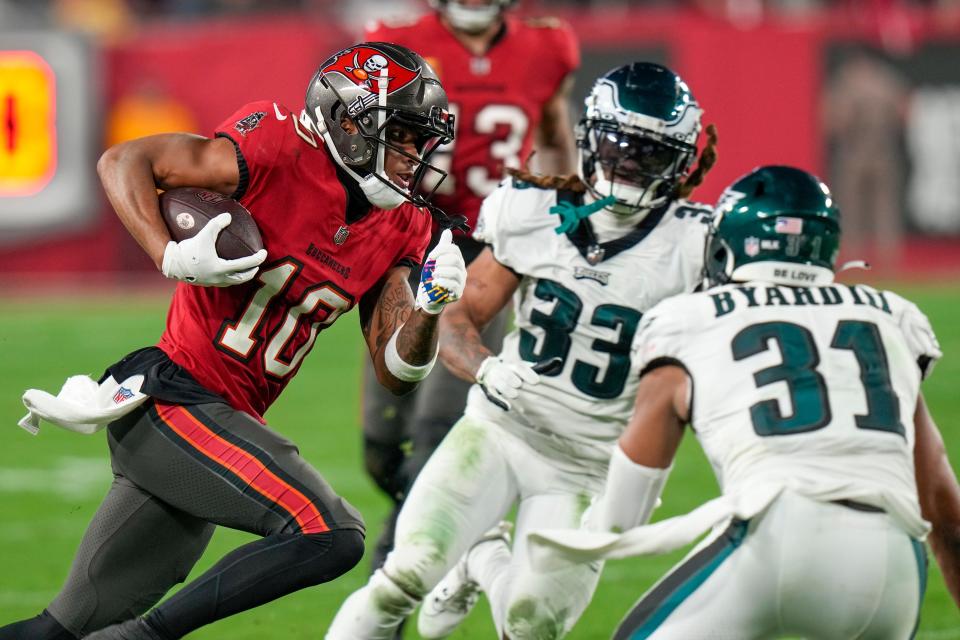 Tampa Bay wide receiver Trey Palmer (10) runs for a touchdown after making a catch as Philadelphia cornerback Bradley Roby (33) and safety Kevin Byard (31) attempt to tackle him in the second half of an NFL wild-card playoff game, Monday, Jan. 15, 2024, in Tampa, Fla.