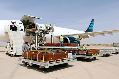 Coffins containing the remains of the bodies of Egyptian Copts killed by Islamic State militants in Sirte are loaded to the plane to be transferred to Egypt, in Misrata, Libya May 14, 2018. REUTERS/Ismail Zitouny