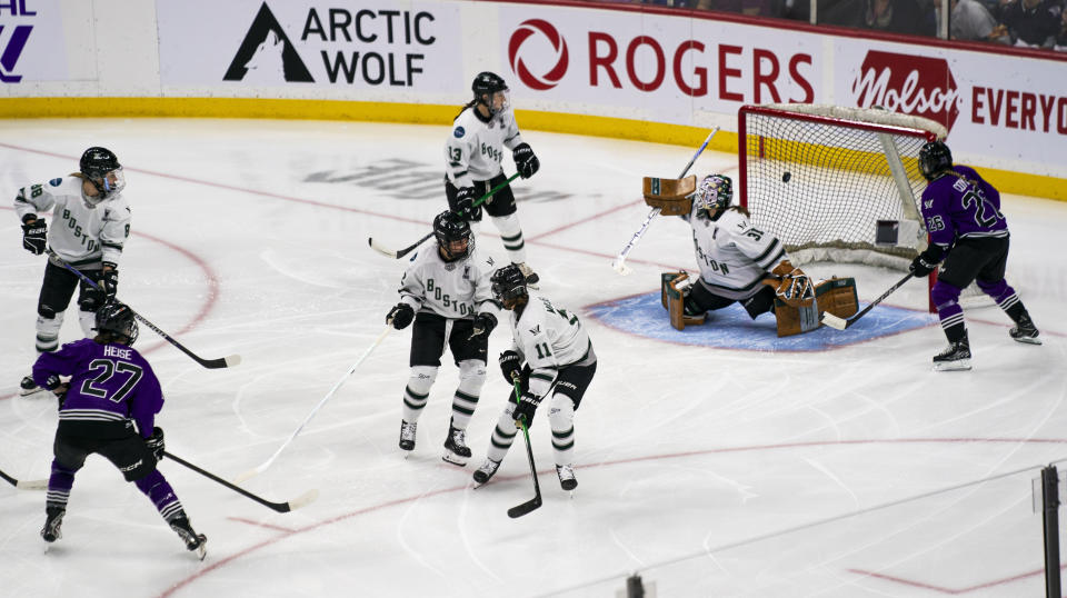 Minnesota forward Taylor Heise (27) scores a goal against Boston during the first period of Game 3 of the PWHL hockey championship series Friday, May 24, 2024, in St. Paul, Minn. (Angelina Katsanis/Star Tribune via AP)