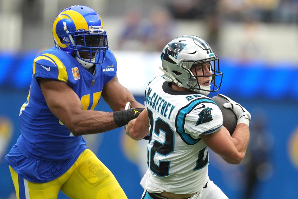 Carolina Panthers running back Christian McCaffrey (22) carries the ball while defended by Los Angeles Rams linebacker Bobby Wagner.