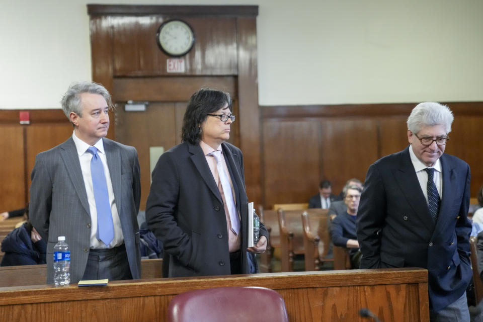 Former Rock & Roll Hall of Fame curator Craig Inciardi, left, memorabilia seller Edward Kosinski, center, andrare-book dealer Glenn Horowitz, left, take their places on the defendants table in the supreme court, Wednesday, Feb. 21, 2024, in New York. A criminal case involving handwritten lyrics to the classic rock megahit “Hotel California” and other Eagles favorites went to trial Wednesday in New York, with three men accused of scheming to thwart band co-founder Don Henley’s efforts to reclaim the allegedly ill-gotten documents. (AP Photo/Mary Altaffer)