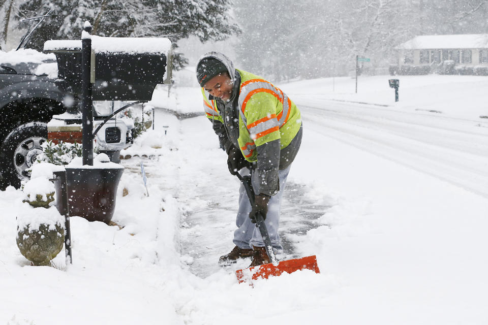 Antwan Wilkerson shovels snow during a winter storm, Sunday, Jan. 31, 2021, in Mechanicsville, Va. (Joe Mahoney/Richmond Times-Dispatch via AP)