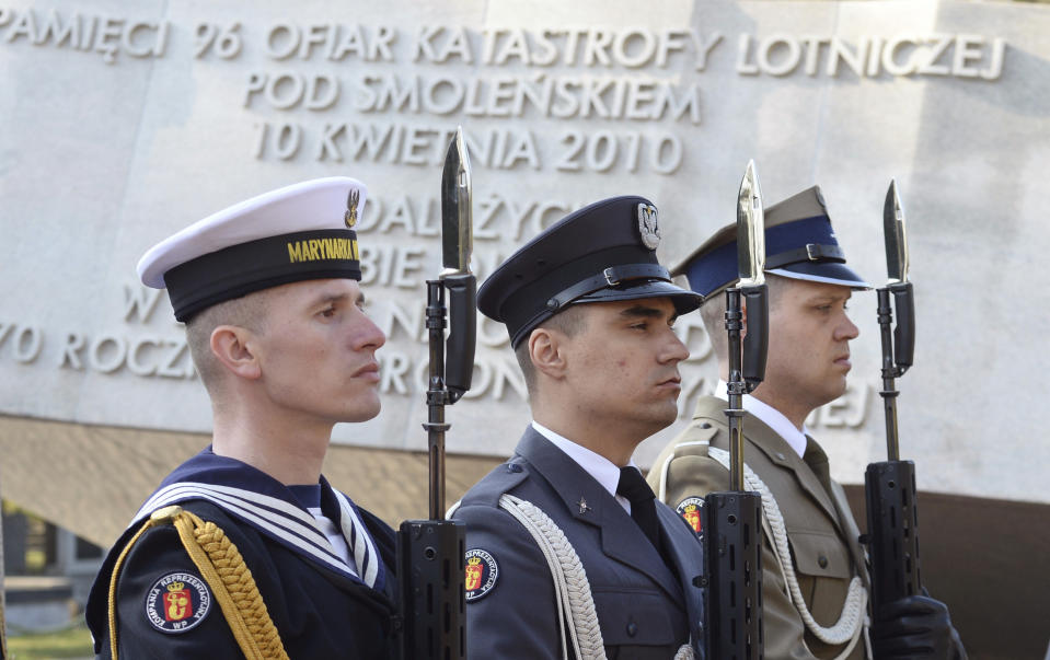 Polish Army soldiers stand attention at the memorial dedicated to the victims of the 2010 presidential plane crash, during a ceremony at the Powazki cemetery, in Warsaw, Poland, Monday, April 10, 2017. Wreath-laying ceremonies have opened Poland's state observances of the seventh anniversary of a plane crash in Russia that killed President Lecha Kaczynski, the first lady and 94 others. (AP Photo/Alik Keplicz)