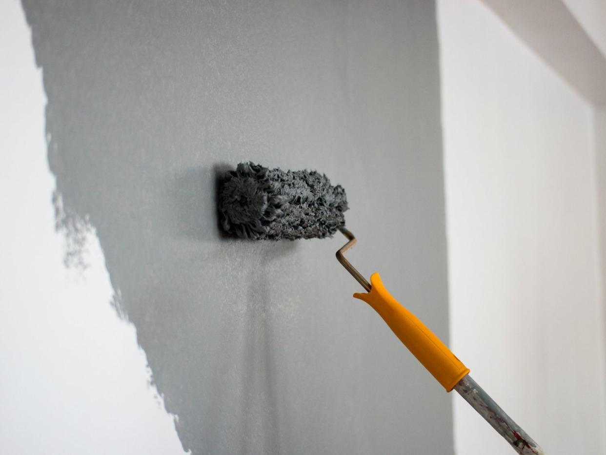 Man painting interior of home