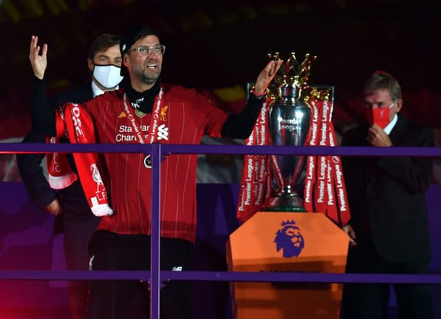 Liverpool manager Jurgen Klopp revels in his success after receiving a Premier League winners' medal. The German became the first title-winning Reds boss since Kenny Dalglish. Club great Dalglish right, was at Anfield as part of the presentation ceremony, sporting a red face mask