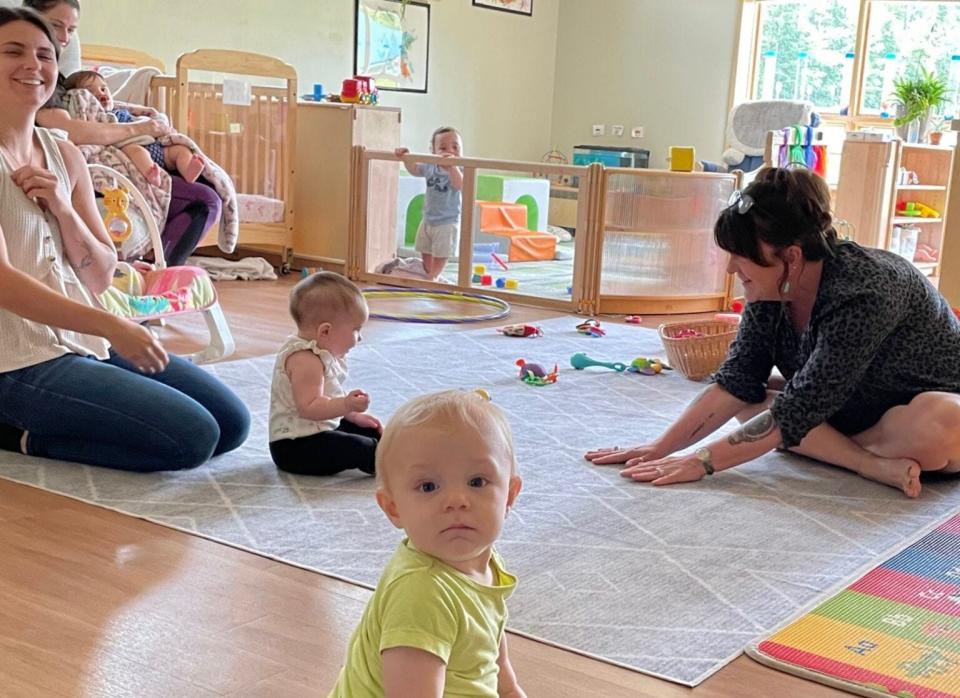 Teachers Madi Dalphonse and Kree Woolley work with infants at the Little Antlers Learning Center in Plymouth.