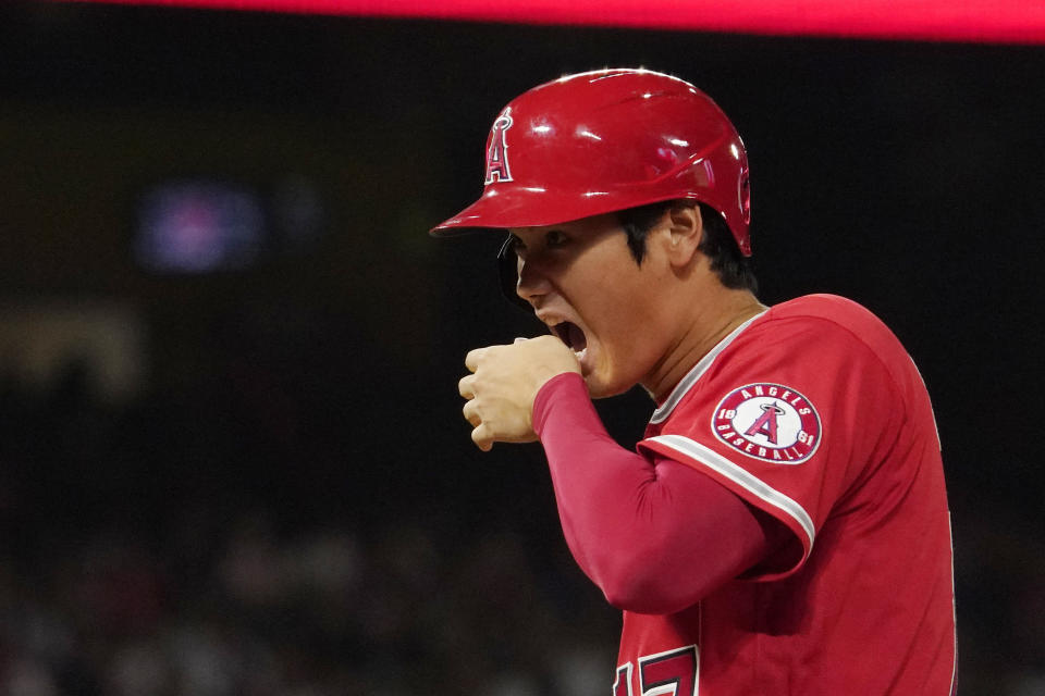 Los Angeles Angels' Shohei Ohtani bites his hand after hitting a single during the sixth inning of a baseball game against the New York Yankees Tuesday, Aug. 30, 2022, in Anaheim, Calif. (AP Photo/Mark J. Terrill)