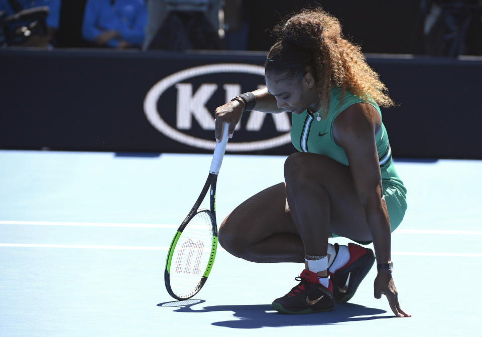 United States' Serena Williams rests on the court during her third round match against Ukraine's Dayana Yastremska at the Australian Open tennis championships in Melbourne, Australia, Saturday, Jan. 19, 2019. (AP Photo/Andy Brownbill)