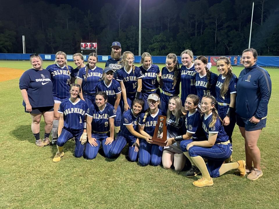 The Gulf Breeze softball team poses for photos after winning the District 1-5A title on Thursday, May 5, 2022 from Pine Forest High School.