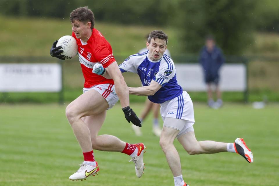 Belnaleck's Darragh McGurn gets away from the challenge of Joe O'Brien, Devenish. <i>(Image: Donnie Phair)</i>