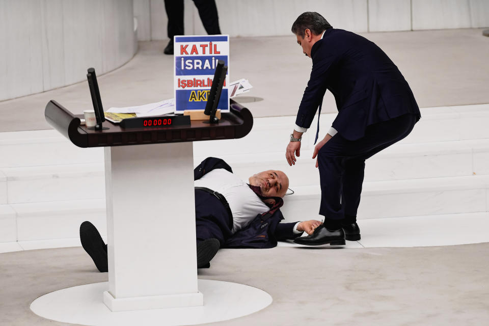 Hasan Bitmez, 53, a Turkish lawmaker from the Islamist Saadet Partisi, or Felicity Party, collapses after speaking at the main chamber of the Turkish parliament in Ankara, Thursday, Dec.14, 2023. Bitmez died in a hospital on Thursday, days after he suffered a heart attack, and collapsed in parliament just after delivering a speech critical of Israel and of the ruling party's relationship with the country. (Selahattin Sonmez/Dia Images via AP)