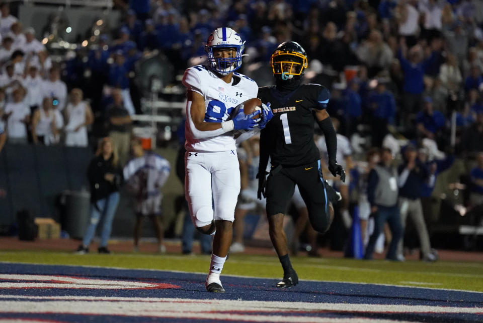 St. Xavier's Jamaal Sharp scores during an OHSAA playoff game against Moeller Friday, Nov. 4 at Norwood High School.