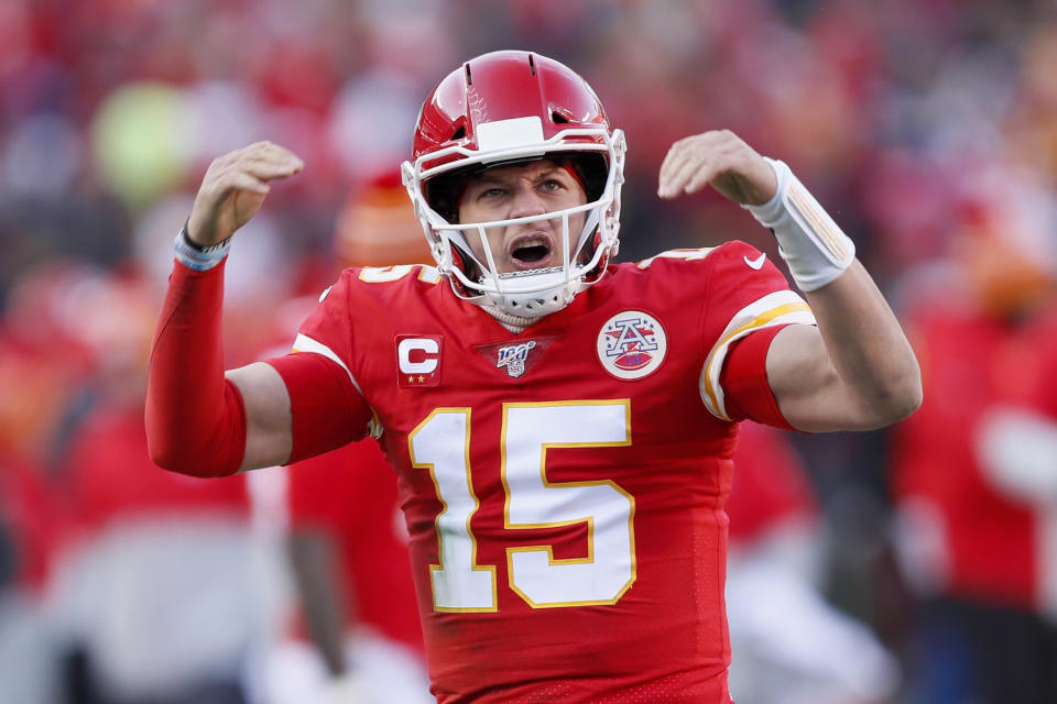 Patrick Mahomes raises his arms in celebration during a game. 