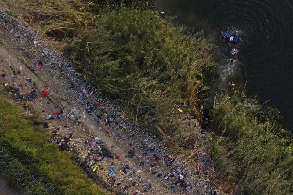 FILE - Migrants use a raft to cross the Rio Grande at the Texas-Mexico border, Thursday, May 11, 2023, in Brownsville, Texas. An 8-year-old girl from Panama born with heart problems died Wednesday, at a Border Patrol station, in the Rio Grande Valley, one of the busiest corridors for migrant crossings, the second death of a child from Latin America in U.S. government custody in two weeks. (AP Photo/Julio Cortez, File)