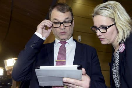 Chairman Juha Sipila (L) of the Centre Party attends a parliamentary elections media reception at the Finnish Parliament Annex in Helsinki April 19, 2015. REUTERS/ Heikki Saukkomaa/Lehtikuva