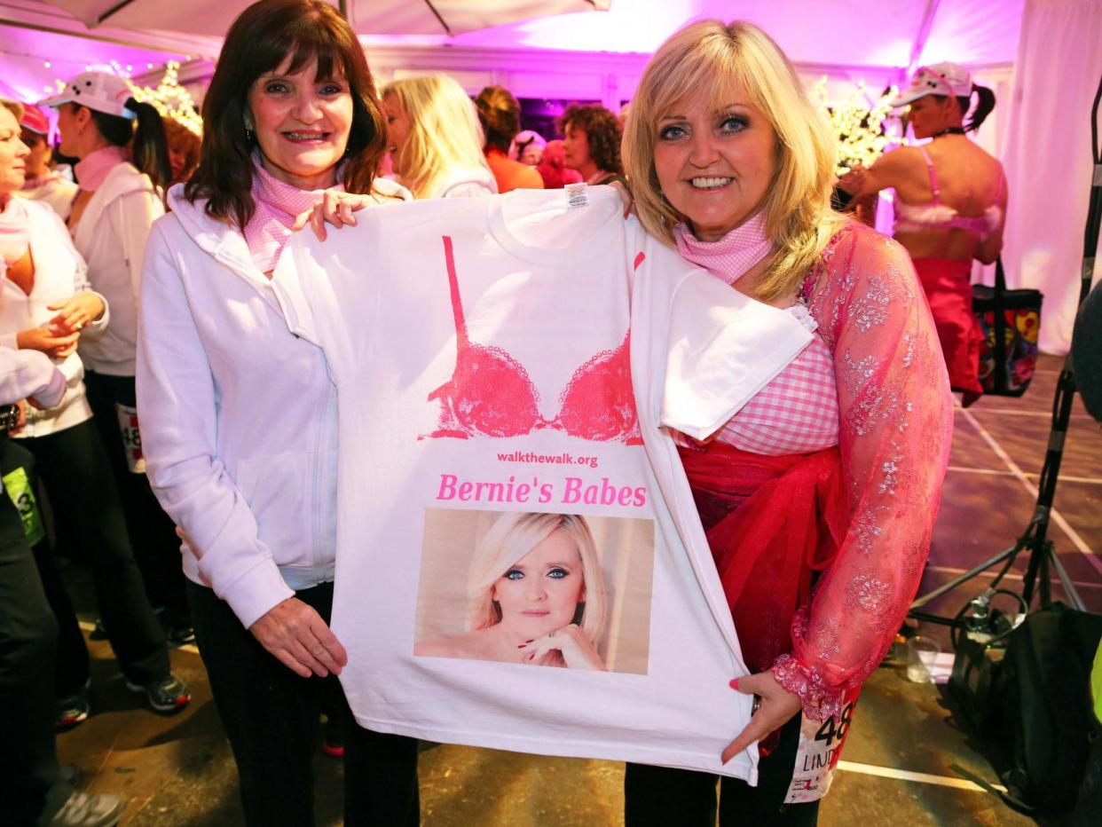 The sisters attend the Walk the Walk Moonwalk charity walk in London on 10 May 2014, holding a T-shirt showing their sister Bernie who died of breast cancer in 2013: Paul Brown/Shutterstock